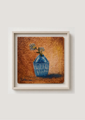 Framed still life wall art showing a blue vase with flowers against a textured brown and gold background, mounted on a light beige wall.
