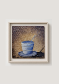 A framed art print depicting a blue cup and saucer with a spoon on a textured brown background, set in a light beige frame against a neutral light gray wall.