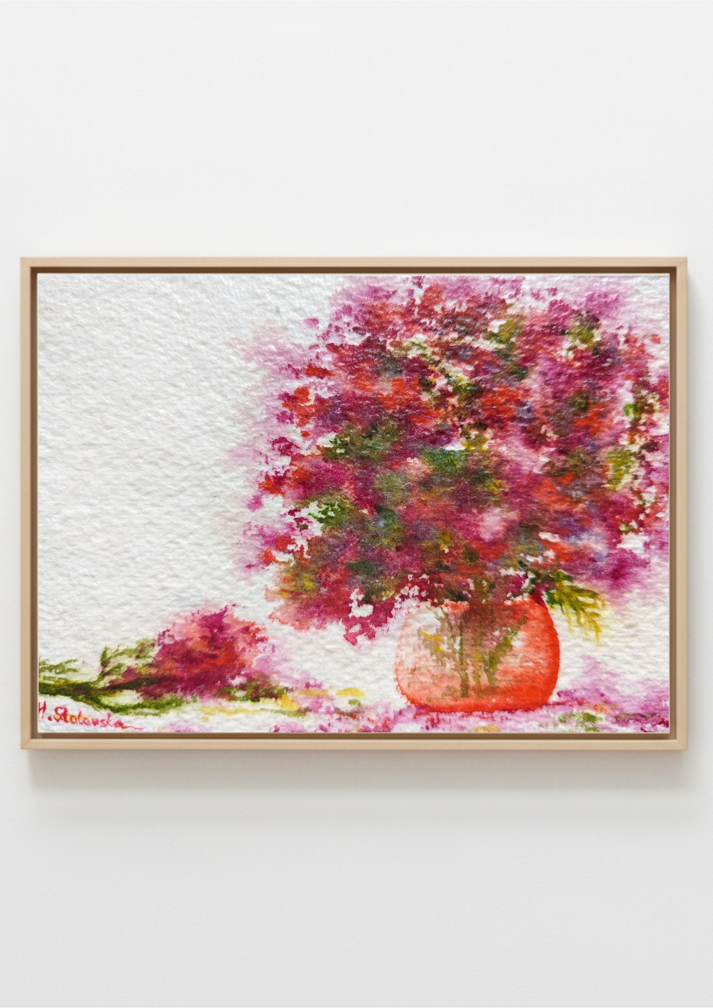 A framed watercolor painting of a vibrant pink and red flower bouquet in a terracotta-colored vase, displayed on a clean white wall.